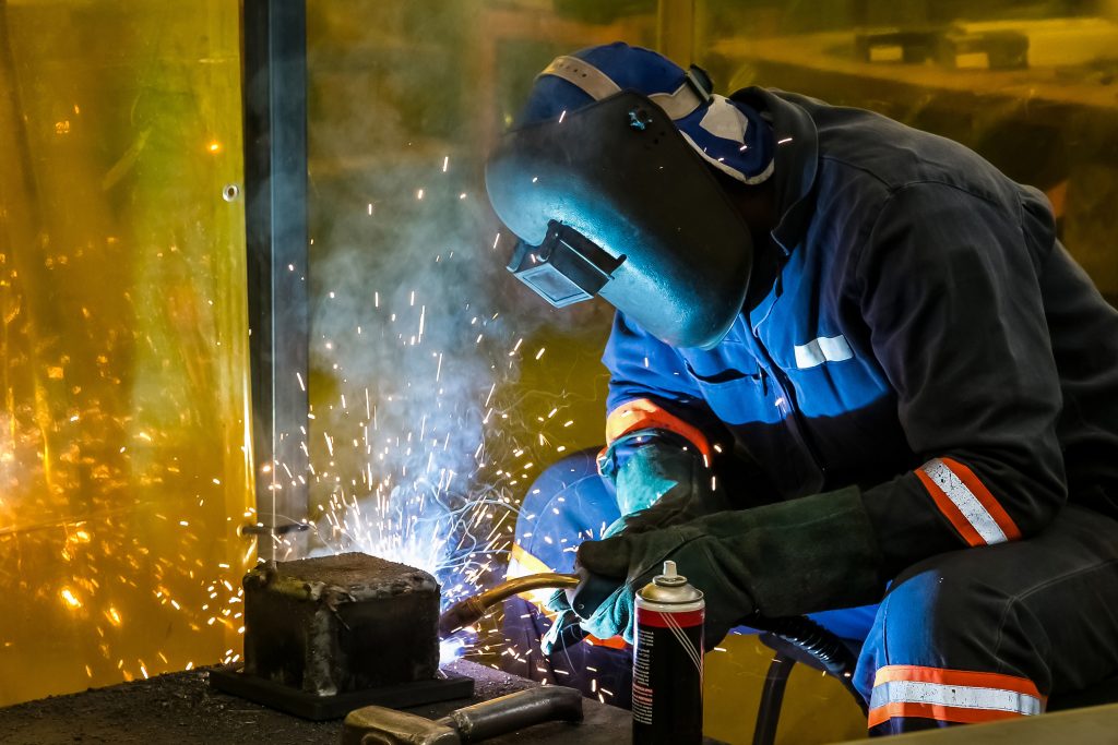 male working with a welding torch