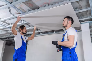 team erectors are repairing ceiling apartment they are wearing blue work clothes 225094 595